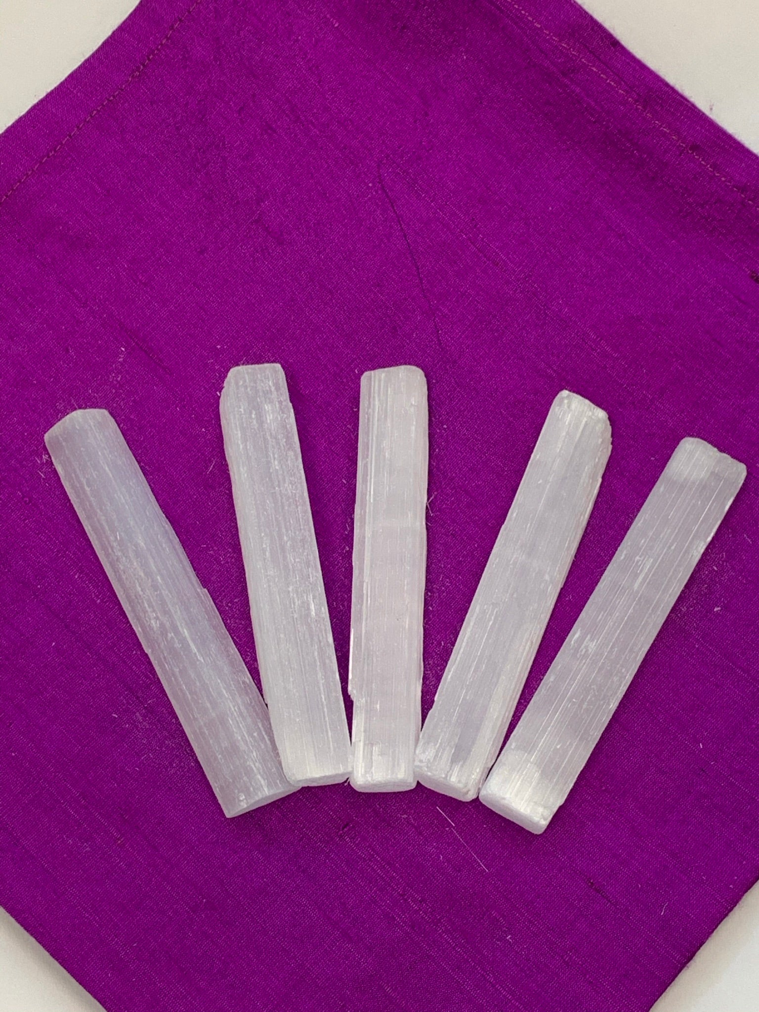 Five-Pack of white selenite wands. They are approximately 4" in length. Each of the five wands will look different as no two are alike. Sizes are approximate. These are great for cleansing your energy. Wave it around you as you would with a sage stick to cleanse your energy and aura. 