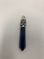 Load image into Gallery viewer, Close-up view. Long Lapis crystal point is set in fancy silver (not sterling) bail. Lapis enhances intuition and psychic abilities, brings peace and serenity, reveals inner truths, aids in self-expression, activates the third eye and and brings balance to the throat chakra. Perfect for wearing to take advantage of its benefits all day long. Approximately 2½&quot;.
