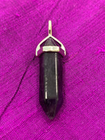 Load image into Gallery viewer, Close-up view. Double terminated amethyst crystal is set in a silver-plated bail (not sterling silver) for this powerful pendant. Amethyst, one of the most spiritual gemstones, heals, cleanses &amp; calms, allowing you to reach meditative &amp; higher consciousness levels more easily. It also helps to dispel negative emotional states. Perfect for wearing to take advantage of its benefits all day long. Approximately 1½&quot;.

