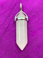 Load image into Gallery viewer, Close-up view. Double terminated rose quartz crystal is set in a silver-plated bail (not sterling silver) for this powerful pendant. Rose quartz is the &quot;stone of unconditional love &amp; infinite peace.&quot; It opens the heart and soothes emotional distress. Perfect for wearing to take advantage of its benefits all day long. Approximately 1½&quot;. 
