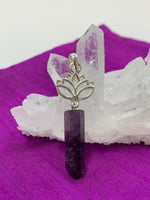 Load image into Gallery viewer, Amethyst crystal point dangles from an open sterling silver lotus. Amethyst, one of the most spiritual gemstones, heals, cleanses &amp; calms, allowing you to reach meditative &amp; higher consciousness levels more easily. It also helps to dispel negative emotional states. The lotus represents purity, strength and enlightenment. Approximately 2¼&quot;.

