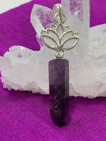 Load image into Gallery viewer, Close-up view. Amethyst crystal point dangles from an open sterling silver lotus. Amethyst, one of the most spiritual gemstones, heals, cleanses &amp; calms, allowing you to reach meditative &amp; higher consciousness levels more easily. It also helps to dispel negative emotional states. The lotus represents purity, strength and enlightenment. Approximately 2¼&quot;.
