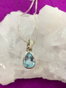 Sparkling and dainty blue topaz teardrop necklace. Sterling Silver. Blue topaz soothes & relaxes, is a stone of love & manifestation, verbal communication & emotional support.  Works well on both 3rd eye & throat chakras. The blue topaz teardrop is approximately ¾" long & the sterling silver chain is 24". Cost is $24.00.