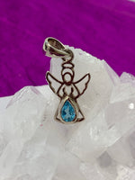 Load image into Gallery viewer, Dainty sterling silver angel pendant with stunning teardrop blue topaz. Blue topaz soothes &amp; relaxes, is a stone of love and manifestation, verbal communication, emotional support and more. The angel reminds us that we are being watched over, always! Pendant is approximately 1&quot; long. Cost is $18.00.
