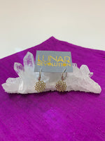 Load image into Gallery viewer, The divine mini-hoop earrings include a crown chakra charm which is hand-cast, hypoallergenic brass, accented by lavender and silver colored beads placed along the sterling silver ear wires, from which the charm dangles. The Crown chakra symbol (Sahasrara) is associated with our connection with Spirit and the Divine.
