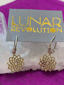 Close-up view. The divine mini-hoop earrings include a crown chakra charm which is hand-cast, hypoallergenic brass, accented by lavender and silver colored beads placed along the sterling silver ear wires, from which the charm dangles. The Crown chakra symbol (Sahasrara) is associated with our connection with Spirit and the Divine.