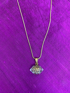 Clear quartz seed necklace. Hand-cast, hypoallergenic brass Seed of Life design wraps around a double-terminated (horizontally set) clear quartz crystal and strung (with a brass bail) on an adjustable 16-20" necklace chain. The Seed of Life is a universal symbol for creation (and much more). Although very beautiful, the handcrafting means you may find differences between necklaces and slight variations or imperfections.