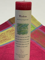 Load image into Gallery viewer, Close-up view of the Reiki-charged pillar candle for &quot;wisdom.&quot; It is handcrafted and scented using essential oils (coconut, mint, cedar &amp; eucalyptus. An affirmation/prayer is printed on the label as well as a listing of the essential oils used. It is approximately 7&quot;x1½&quot;. Perfect for meditation, prayer, visualization or quiet time. This red candle and its label are both visually appealing.
