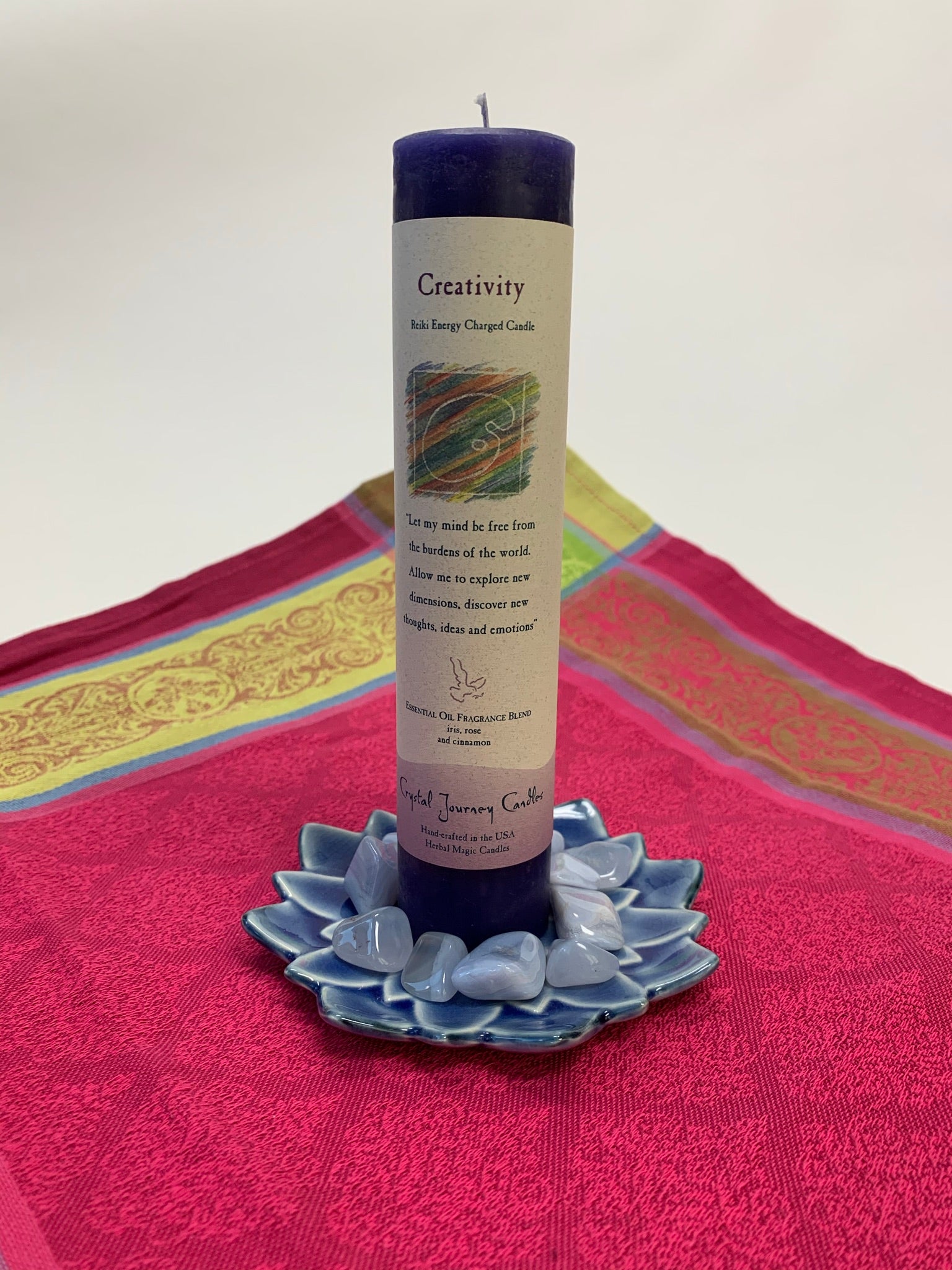 Reiki-charged pillar candle for "creativity." It is handcrafted and scented using essential oils. An affirmation/prayer is printed on the label, as well as a listing of the essential oils used (iris, rose & cinnamon). It is approximately 7"x2½." Perfect for Meditation, prayer, visualization or quiet time. This dark blue candle and its label are both visually appealing. 