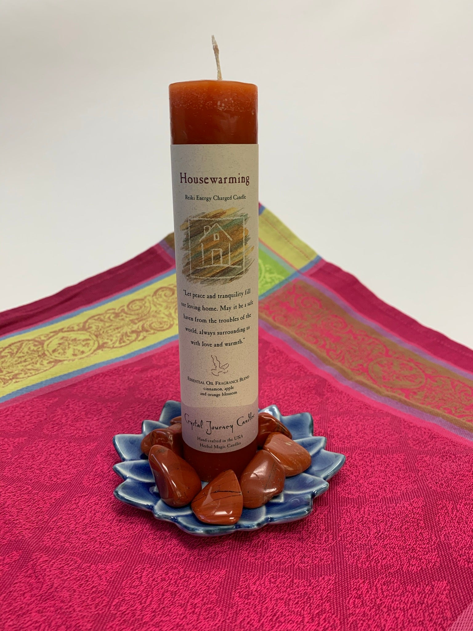 Reiki-charged pillar candle for "Housewarming" energy - bringing love, peace and warmth to any home. It is handcrafted and scented using essential oils. An affirmation/prayer is printed on the label, a well as a listing of the essential oils used (cinnamon, apple and orange blossom). It is approximately 7"x2½". Perfect for meditation, visualization or quiet time. This mahogany brown candle and its label are both visually appealing.