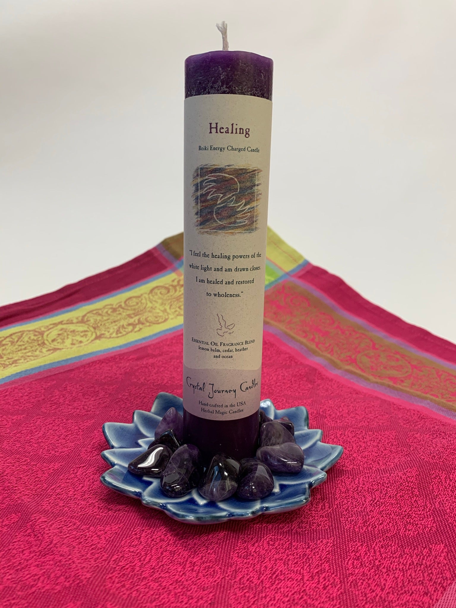 Reiki-charged pillar candle for "Healing." It is handcrafted and scented using essential oils. An affirmation/prayer is printed on the label, a well as a listing of the essential oils used (lemon balm, cedar, heather, ocean). It is approximately 7"x2½". Perfect for meditation, prayer, visualization or quiet time. This deep purple candle and its label are both visually appealing.