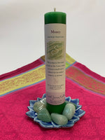 Load image into Gallery viewer, Reiki-charged pillar candle energized for manifesting &quot;money.&quot; It is handcrafted and scented using essential oils. An affirmation/prayer is printed on the label, as well as a listing of the essential oils used (nutmeg, clove, citronella, cinnamon, myrrh, rain). It is approximately 7&quot;x2½&quot;. Perfect for meditation, prayer, visualization or quiet time. This green candle and its label are both visually appealing.
