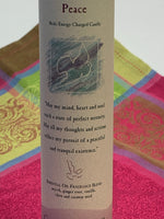 Load image into Gallery viewer, Close-up view of the label on the Reiki-charged pillar candle infused with the energy of &quot;peace.&quot; It is handcrafted and scented using essential oils. An affirmation/prayer is printed on the label, as well as a listing of the essential oils used (myrrh, ginger root, vanilla, clove, caraway seed). It is approximately 7&quot;x2½&quot;. Perfect for meditation, prayer, visualization or quiet time. This deep green candle and its label are both visually appealing.
