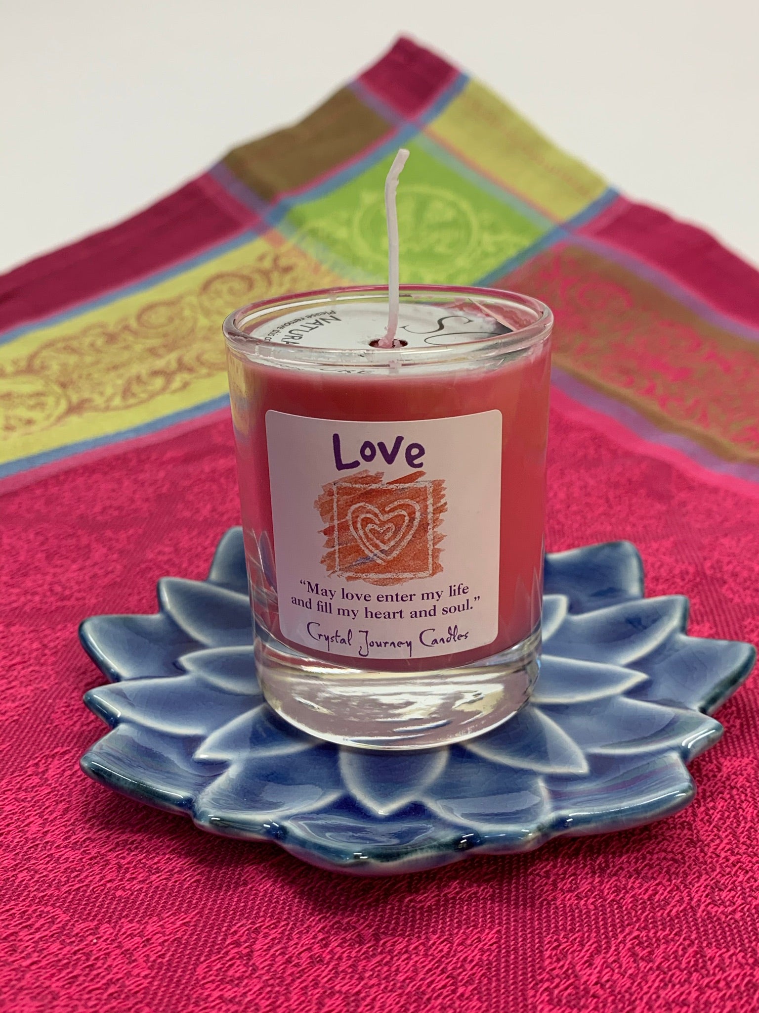Handcrafted pink votive candle in a glass holder. The wax is soy-based (no paraffin) and is also vegan. Wicks are made with paper and cotton only. It comes with an attractive label stating the intention/purpose of the candle, "Love," and an affirmation for your use: "May love enter my life and fill my heart and soul"