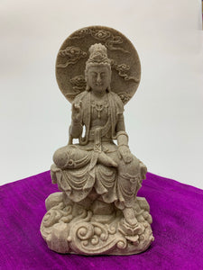 Lovely, detailed sandstone & resin cast statue of Kwan Yin sitting in a pose in which she is often seen.  Kwan Yin is a revered and powerful goddess. She symbolizes compassion, mercy, kindness and unconditional love. She appears to be connected to both Spirit (sky and clouds) and the earth, with her foot on the lotus flower. She stands approximately 7½" tall. Add her to your altar, meditation space or use as décor anywhere in your home or office.