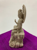 Load image into Gallery viewer, Right side view. Lovely, detailed sandstone &amp; resin cast statue of Kwan Yin sitting in a pose in which she is often seen. Kwan Yin is a revered and powerful goddess. She symbolizes compassion, mercy, kindness and unconditional love. She appears to be connected to both Spirit (sky and clouds) and the earth, with her foot on the lotus flower. She stands approximately 7½&quot; tall. Add her to your altar, meditation space or use as décor anywhere in your home or office.
