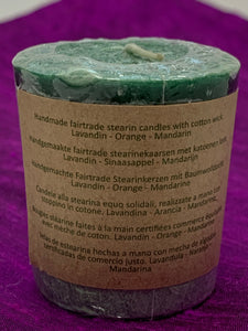 Close up of one of the 7 candles - back of label. Lovely scented set of chakra candles, one representing each of the 7 major chakras. Made with natural essential oils. They are handmade and fair trade (workers receive fair wages for their work). Comes with information/instruction sheet. Use for meditation or chakra awakening/alignment. Each candle is approximately 1.75". These candles are handmade and fair trade.