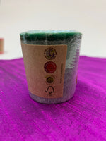 Load image into Gallery viewer, Close up of one of the 7 candles - side of label. Lovely scented set of chakra candles, one representing each of the 7 major chakras. Made with natural essential oils. They are handmade and fair trade (workers receive fair wages for their work). Comes with information/instruction sheet. Use for meditation or chakra awakening/alignment. Each candle is approximately 1.75&quot;. These candles are handmade and fair trade.
