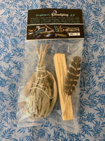 Load image into Gallery viewer, This is a mini smudging kit. It includes a small white sage smudging stick, a Palo Santo stick, a small smudging feather and a small abalone shell. Smudging with sage has its roots in Native American traditions. Use it to: *Cleanse, clear &amp; purify your space or environment - home, office, *Cleanse, clear or purify a person &amp; their energy *Promote healing *Promote clarity of mind *Clear out spiritual impurities *Enhance ceremony or ritual. Cost is $9.50.
