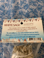 Load image into Gallery viewer, Close-up of product info tag. This white sage smudge stick is made of 100% natural botanicals and sustainable methods are used in wildcrafting it. Smudging with sage has its roots in Native American traditions. Use it to: *Cleanse, clear &amp; purify your space or environment - home, office, *Cleanse, clear or purify a person &amp; their energy *Promote healing *Promote clarity of mind *Clear out spiritual impurities *Enhance ceremony or ritual This smudge stick is approximately 6&quot;x1½&quot;. *This product includes 1 sag
