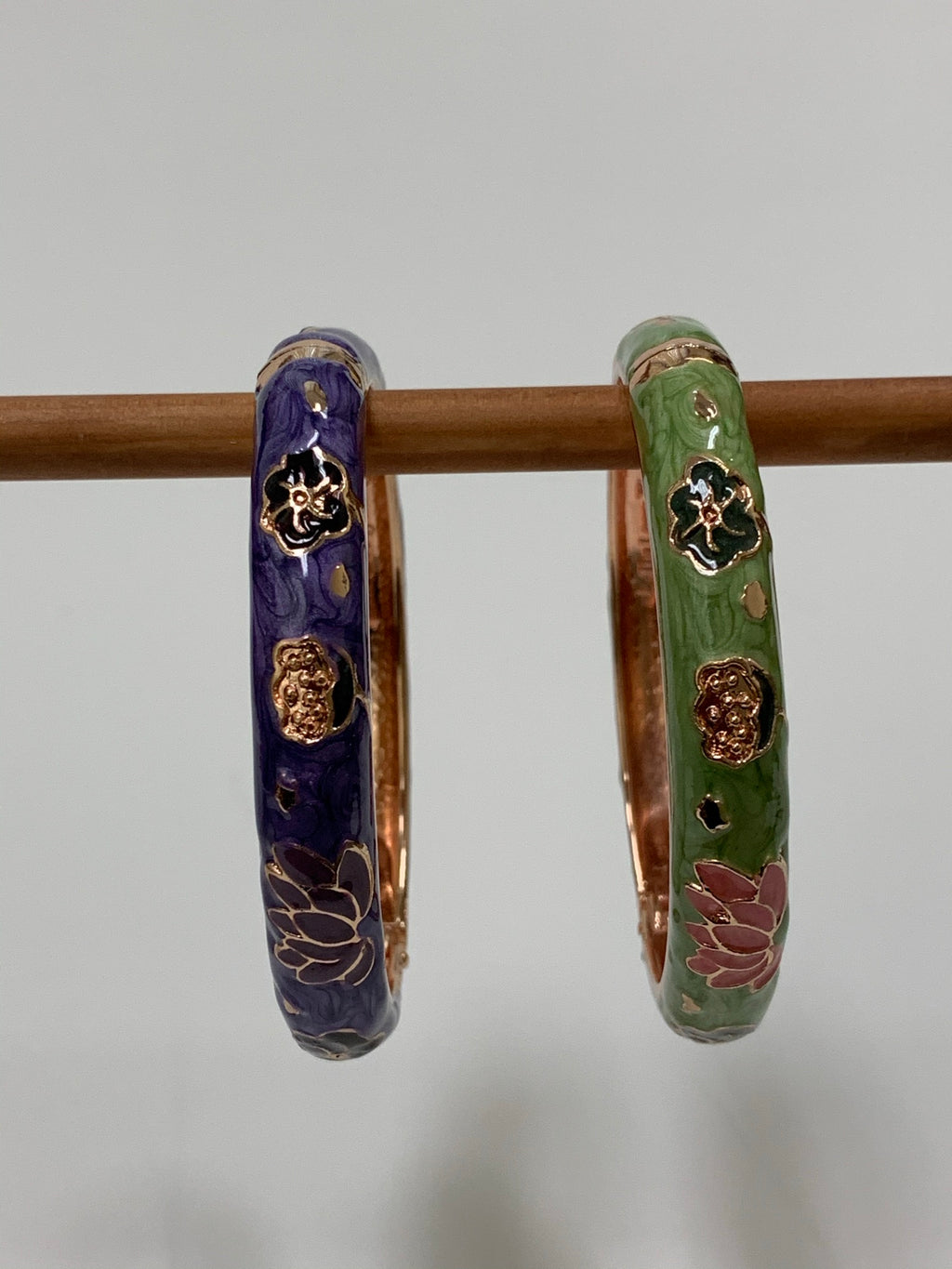 Set of 2 beautiful bangle bracelets (purple & green) with intricate metal work and enamel finish. Apparently when enamel is heated up to very high temperatures, it becomes "vibrant in color with a wonderful metallic finish." The design includes lovely lotus flowers. Lotus symbolizes purity, strength and enlightenment and reminds us that we all must move through the muck to reach the light ♥. See the other set in my store (black & red).