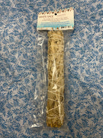 Load image into Gallery viewer, This white sage smudge stick is made of 100% natural botanicals and sustainable methods are used in wildcrafting it. Smudging with sage has its roots in Native American traditions. Use it to: *Cleanse, clear &amp; purify your space or environment - home, office,  *Cleanse, clear or purify a person &amp; their energy *Promote healing *Promote clarity of mind *Clear out spiritual impurities  *Enhance ceremony or ritual. Approximately 9.5&quot;x2&quot;. Cost is $8.50.

