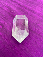 Load image into Gallery viewer, View of the point. Beautiful clear crystal point holds both beauty and meaning. Quartz is the &quot;most powerful healing and energy amplifier on the planet&quot; (Judy Hall). It is cleansing to organs of the physical body and It also cleanses the soul and it increases your spiritual energy to the highest level (and so much more). Place this on your altar, book shelf, nightstand or table. Use for meditation, healing, cleansing and more. Point is approximately 1½&quot; tall. Cost is $5.98.
