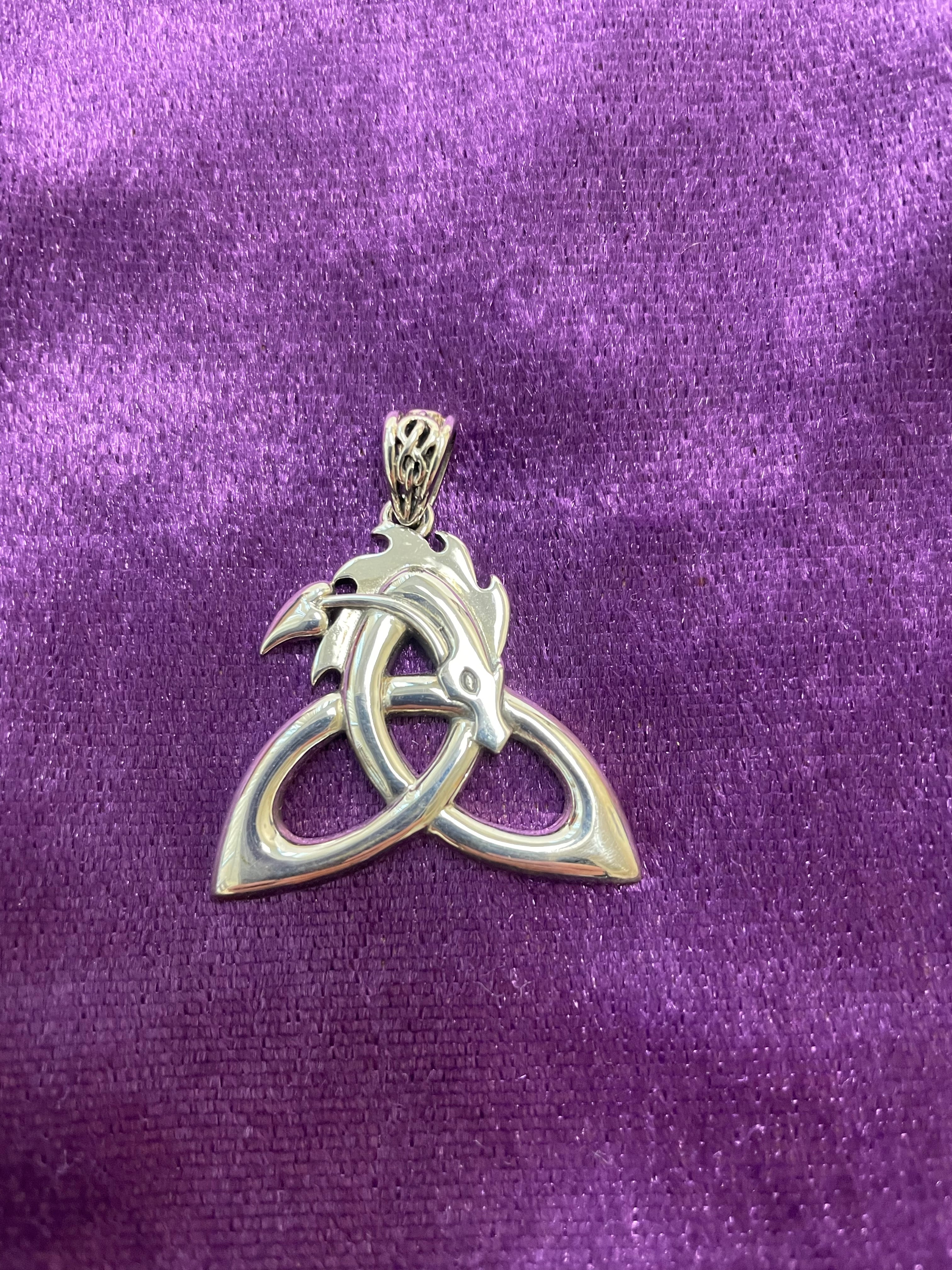 Another view of  the stunning sterling silver dragon pendant forming a Celtic triquetra or trinity knot with a Celtic design on the bail. Approximately 1¼" without bail, 1½" with bail. Cost is $34.98.