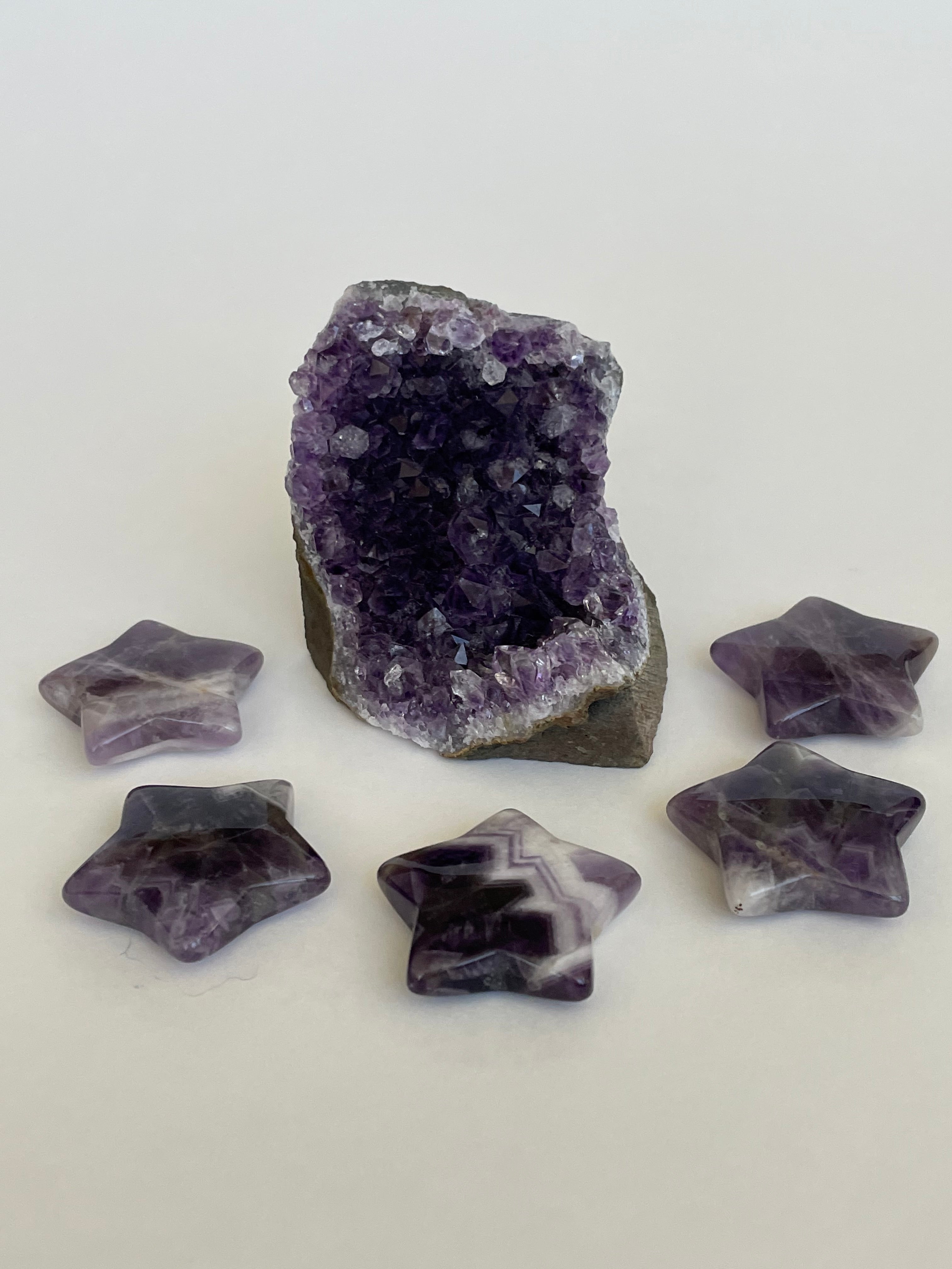 View of several amethyst stars. Love the banding on this particular chevron amethyst star. It can be used for meditation, healing, for your altar or as décor for any room in your home or office. Easy to slip right into your pocket so you have the energy of amethyst everywhere you go. Approximately 1¼". Cost is $6 for one star.