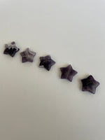 Load image into Gallery viewer, Another view of several amethyst stars. Love the banding on this particular chevron amethyst star. It can be used for meditation, healing, for your altar or as décor for any room in your home or office. Easy to slip right into your pocket so you have the energy of amethyst everywhere you go. Approximately 1¼&quot;. Cost is $6 for one star. 
