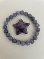 Load image into Gallery viewer, View of reverse side of lepidolite star. This lovely little Lepidolite star can be used for meditation, healing, for your altar, on your computer to clear EMRs, or as décor for any room in your home or office. Easy to slip right into your pocket so you have the energy of lepidolite everywhere you go. Approximately 1¼&quot;. Cost is $6.
