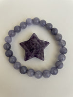 Load image into Gallery viewer, This lovely little Lepidolite star can be used for meditation, healing, for your altar, on your computer to clear EMRs, or as décor for any room in your home or office. Easy to slip right into your pocket so you have the energy of lepidolite everywhere you go. Approximately 1¼&quot;. Cost is $6.
