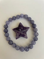 Load image into Gallery viewer, Reverse side of lepidolite star. This lovely little Lepidolite star can be used for meditation, healing, for your altar, on your computer to clear EMRs, or as décor for any room in your home or office. Easy to slip right into your pocket so you have the energy of lepidolite everywhere you go. Approximately 1¼&quot;. Cost is $6.
