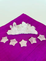 Load image into Gallery viewer, View of several crystal quartz stars. This powerful little quartz crystal star can be used for meditation, healing, for your altar, or as décor for any room in your home or office. Easy to slip right into your pocket so you can take the energy of Quartz everywhere you go. Quartz is the &quot;most powerful healing and energy amplifier on the planet&quot; (Judy Hall). Approximately 1¼&quot;. Cost is $6 for one star. 
