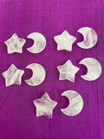 Load image into Gallery viewer, View of several quartz crystal crescent moons &amp; stars (which are sold separately). This powerful little quartz crystal crescent moon can be used for meditation, healing, for your altar, or as décor for any room in your home or office. Easy to slip right into your pocket so you can take the energy of quartz everywhere you go. Quartz is the &quot;most powerful healing and energy amplifier on the planet&quot; (Judy Hall). Approx. 1¼&quot;. Cost is $6 for one moon.
