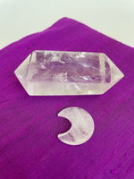 Load image into Gallery viewer, Reverse side of quartz crystal crescent moon. This powerful little quartz crystal crescent moon can be used for meditation, healing, for your altar, or as décor for any room in your home or office. Easy to slip right into your pocket so you can take the energy of quartz everywhere you go.  Quartz is the &quot;most powerful healing and energy amplifier on the planet&quot; (Judy Hall). Approx. 1¼&quot;. Cost is $6. 
