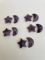 Load image into Gallery viewer, View of several lepidolite crescent moons &amp; stars (which are sold separately). . This sparkly little lavender colored lepidolite crescent moon can be used for meditation, healing, for your altar, on/near your computer or as décor for any room in your home or office. Easy to slip right into your pocket so you can take the energy of lepidolite everywhere you go. Approx. 1¼&quot;. Cost is $6 for one moon.
