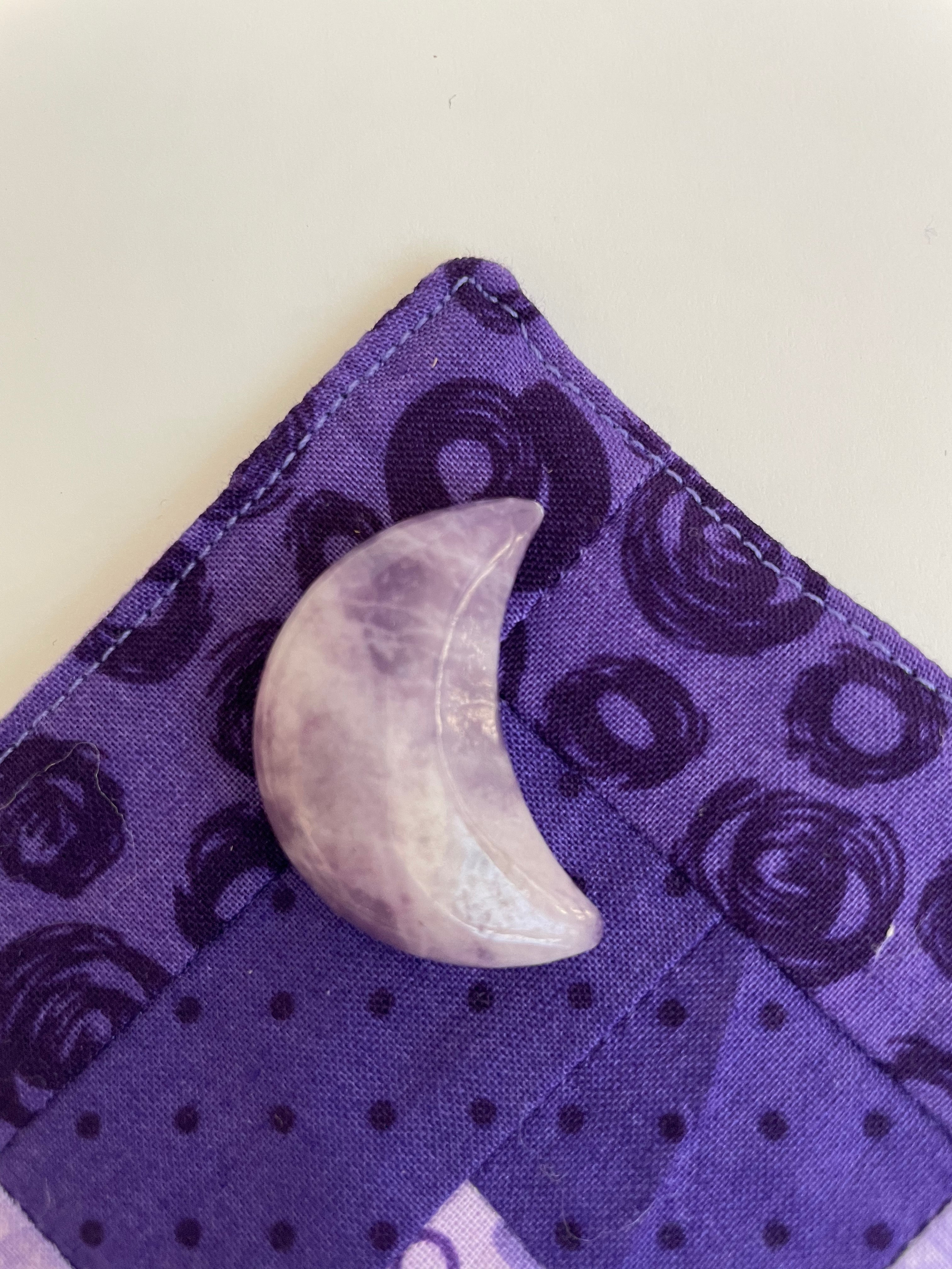 Reverse side of lepidolite crescent moon. ﻿This sparkly little lavender-colored lepidolite crescent moon can be used for meditation, healing, for your altar, on/near your computer or as décor for any room in your home or office. Easy to slip right into your pocket so you can take the energy of lepidolite everywhere you go. Approx. 1¼". Cost is $6.