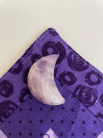 Load image into Gallery viewer, Reverse side of lepidolite crescent moon. ﻿This sparkly little lavender-colored lepidolite crescent moon can be used for meditation, healing, for your altar, on/near your computer or as décor for any room in your home or office. Easy to slip right into your pocket so you can take the energy of lepidolite everywhere you go. Approx. 1¼&quot;. Cost is $6.
