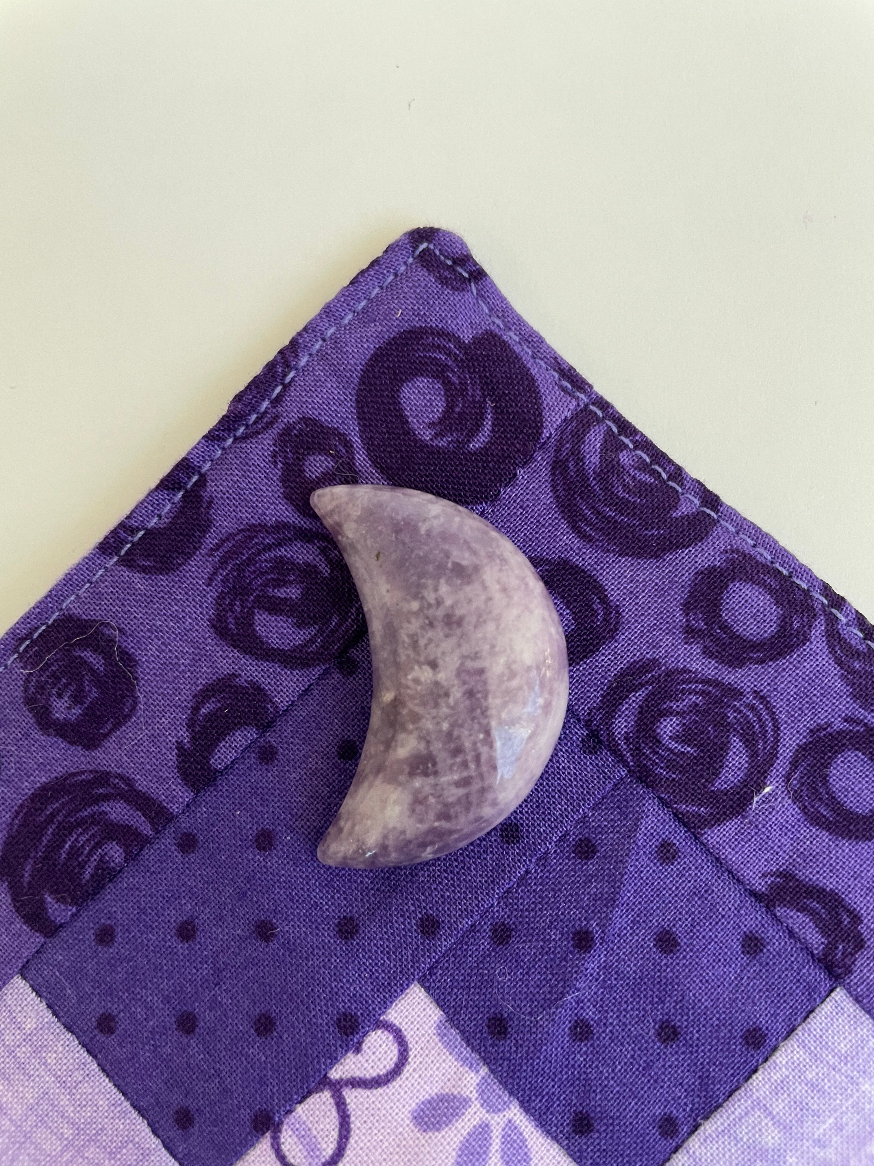 Reverse side of lepidolite crescent moon. ﻿This sparkly little lavender-colored lepidolite crescent moon can be used for meditation, healing, for your altar, on/near your computer or as décor for any room in your home or office. Easy to slip right into your pocket so you can take the energy of lepidolite everywhere you go. Approx. 1¼". Cost is $6.