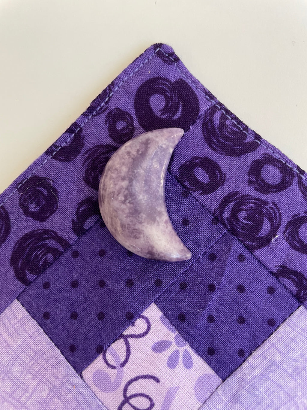 ﻿This sparkly little lavender-colored lepidolite crescent moon can be used for meditation, healing, for your altar, on/near your computer or as décor for any room in your home or office. Easy to slip right into your pocket so you can take the energy of lepidolite everywhere you go. Approx. 1¼". Cost is $6. 