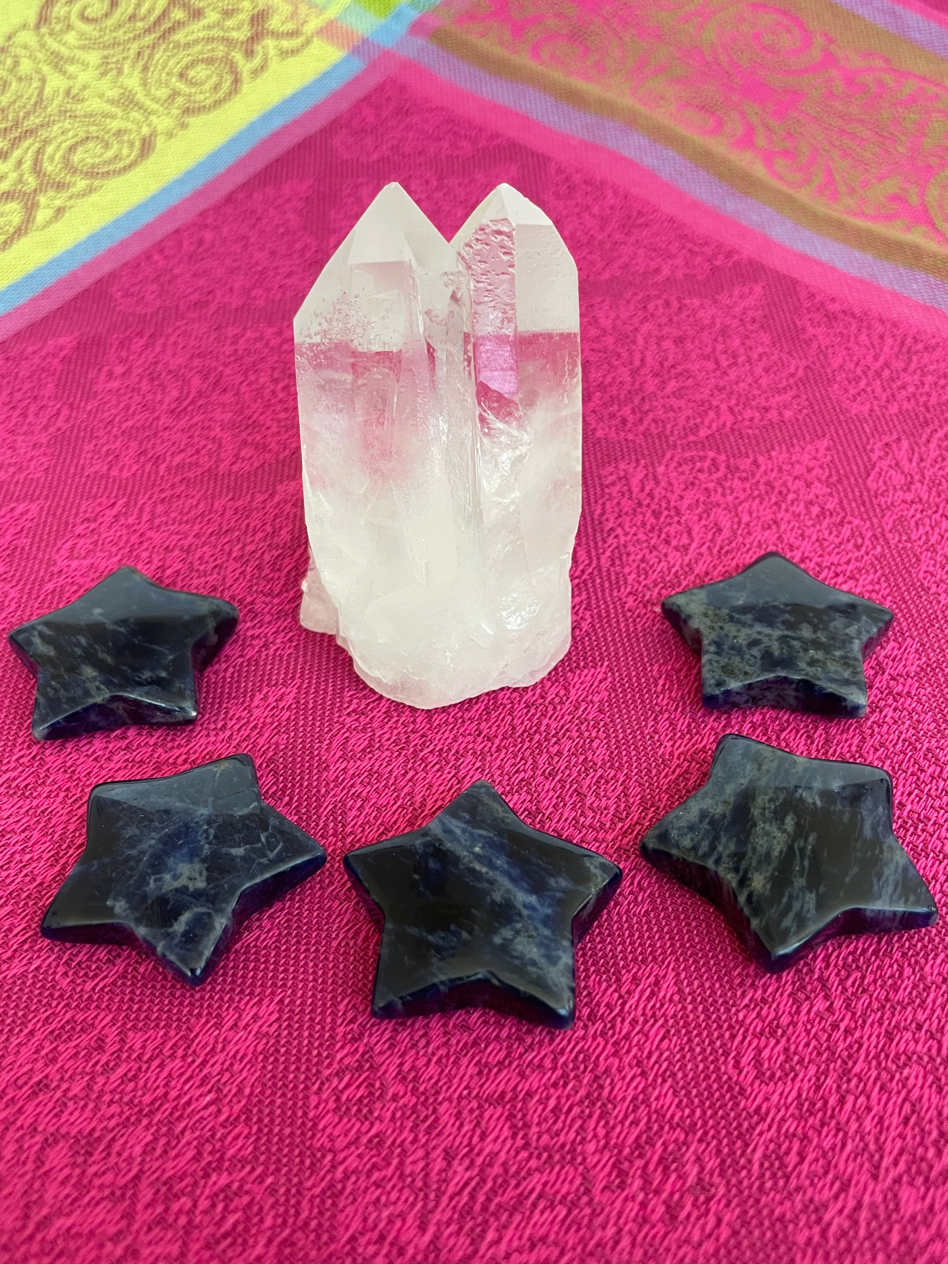 View of several sodalite stars. This powerful little sodalite crystal star can be used for meditation, healing, as an altar piece or as décor for any room in your home or office. Makes a wonderful gift too! Easy to slip right into your pocket so you can take the energy of sodalite wherever you go! Sodalite "Unites logic with intuition and opens spiritual perception" (Judy Hall). Approx. 1¼". Cost is $6 for one star. 