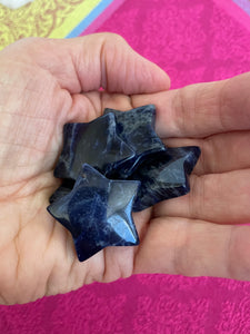 View of several sodalite stars. This powerful little sodalite crystal star can be used for meditation, healing, as an altar piece or as décor for any room in your home or office. Makes a wonderful gift too! Easy to slip right into your pocket so you can take the energy of sodalite wherever you go! Sodalite "Unites logic with intuition and opens spiritual perception" (Judy Hall). Approx. 1¼". Cost is $6 for one star.
