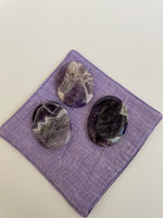 Load image into Gallery viewer, Alternate view of Chevron amethyst palm stone. Beautiful amethyst palm stone can be used for meditation, healing, for your altar or as a décor item. Amethyst, one of the most spiritual gemstones, heals, cleanses &amp; calms, allowing you to reach meditative &amp; higher consciousness levels more easily. It also helps to dispel negative emotional states and more. Chevron amethyst is a combination of amethyst and white quartz and when you add the quartz you get additional qualities. 2&quot; long. Cost $12.
