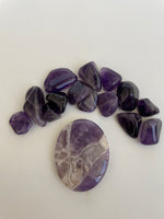 Load image into Gallery viewer, Lovely lavender colored Chevron amethyst palm stone can be used for meditation, healing, for your altar or as décor for any room in your home or office. Amethyst, one of the most spiritual gemstones, heals, cleanses &amp; calms, allowing you to reach meditative &amp; higher consciousness levels more easily. It also helps to dispel negative emotional states and more. Chevron amethyst is a combination of amethyst and white quartz and when you add the quartz you get additional qualities. 2&quot; long. Cost is $12.

