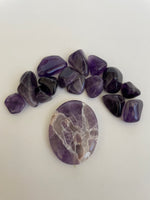 Load image into Gallery viewer, Back side. Lovely lavender colored Chevron amethyst palm stone can be used for meditation, healing, for your altar or as a décor item. Amethyst, one of the most spiritual gemstones, heals, cleanses &amp; calms, allowing you to reach meditative &amp; higher consciousness levels more easily. It also helps to dispel negative emotional states and more. Chevron amethyst is a combination of amethyst and white quartz and when you add the quartz you get additional qualities. 2&quot; long. Cost is $12.
