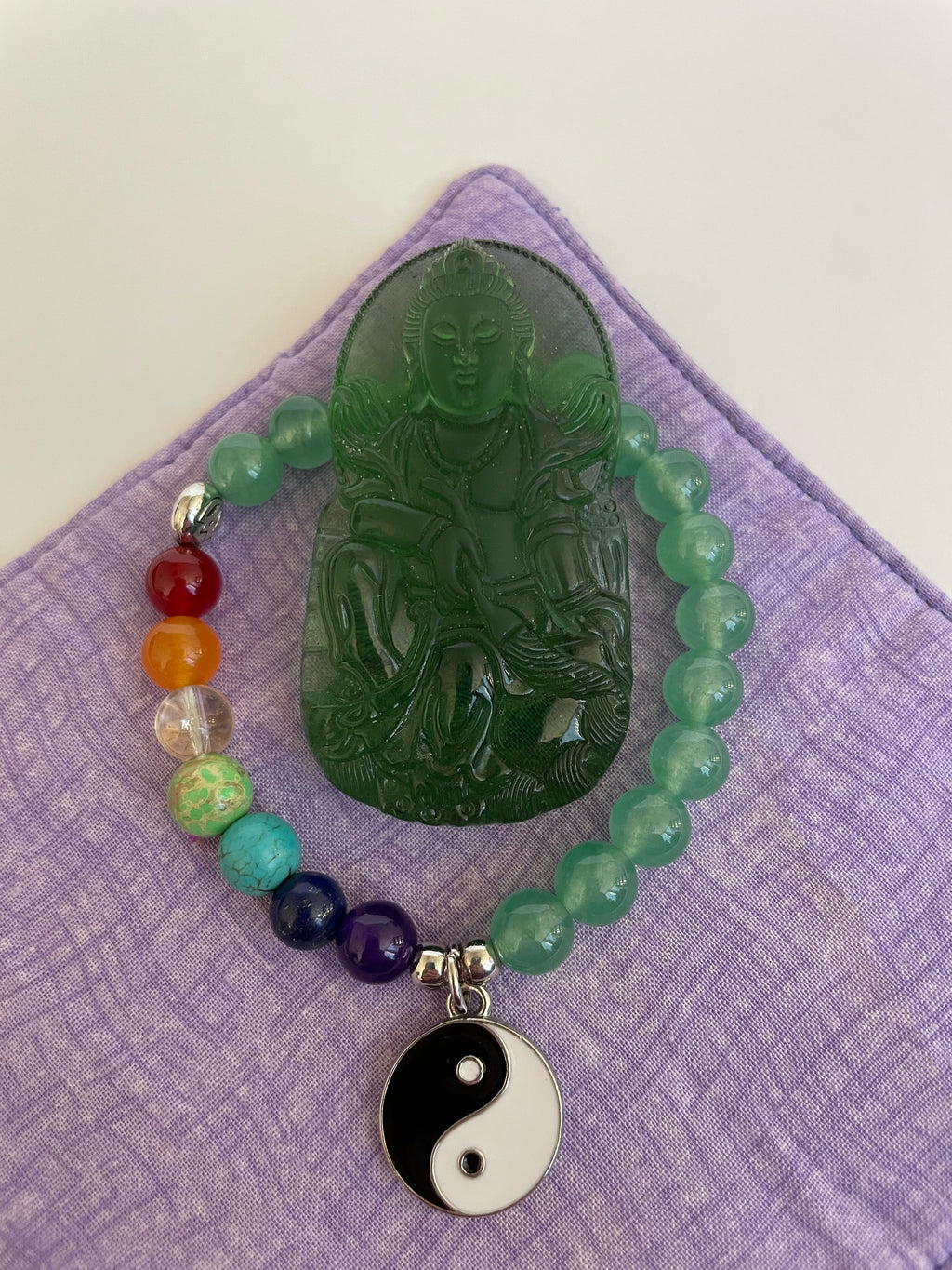 Deep green glass Buddha can be used as pendant (small hole at top) or as a décor item for your altar or bookshelf. The beautiful detailing makes this a special piece. Buddha is revered around the world and his teachings and actions have shown us the beauty, wonder and power of enlightenment. The term Buddha refers to the Awakened One. . He is approximately 2½" tall. Cost is $10.