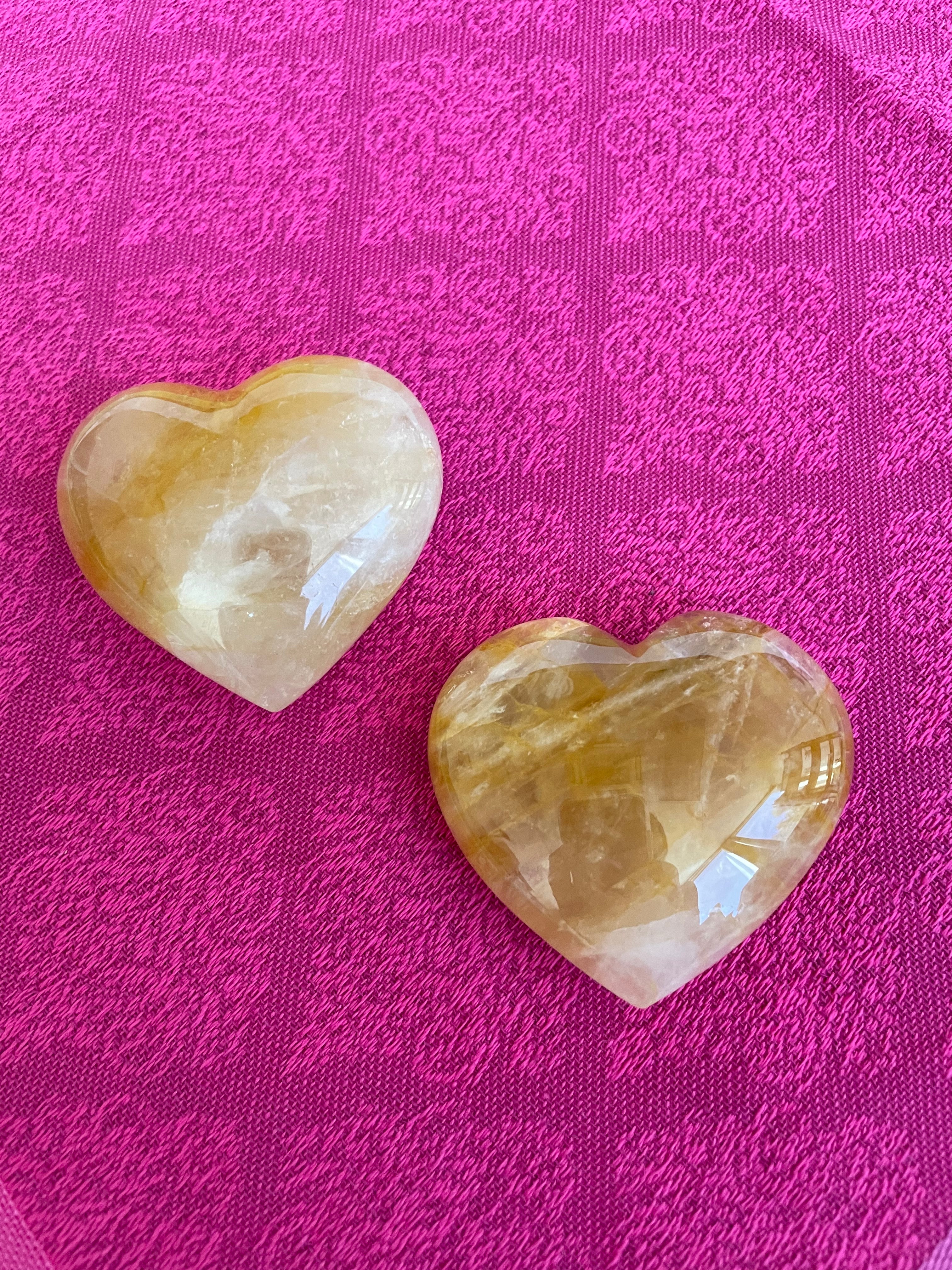 Alternate view. Beautiful citrine (yellow quartz) heart! Great to place on your altar or bookshelf, to hold during meditation, to use for healing or as a décor item in your home of office. Citrine absorbs and dispels negative energy, is a stone of abundance - attracting money, prosperity and success, warming & energizing, enhances creativity, brings a positive attitude, is cleansing and more. This citrine heart is approximately 2" at it's widest expanse. Cost is $24.