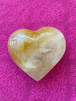 Load image into Gallery viewer, Alternate view/front. Beautiful citrine (yellow quartz) heart! Great to place on your altar or bookshelf, to hold during meditation, to use for healing or as a décor item in your home of office. Citrine absorbs and dispels negative energy, is a stone of abundance - attracting money, prosperity and success, warming &amp; energizing, enhances creativity, brings a positive attitude, is cleansing and more. This citrine heart is approximately 2&quot; at it&#39;s widest expanse. Cost is $24.
