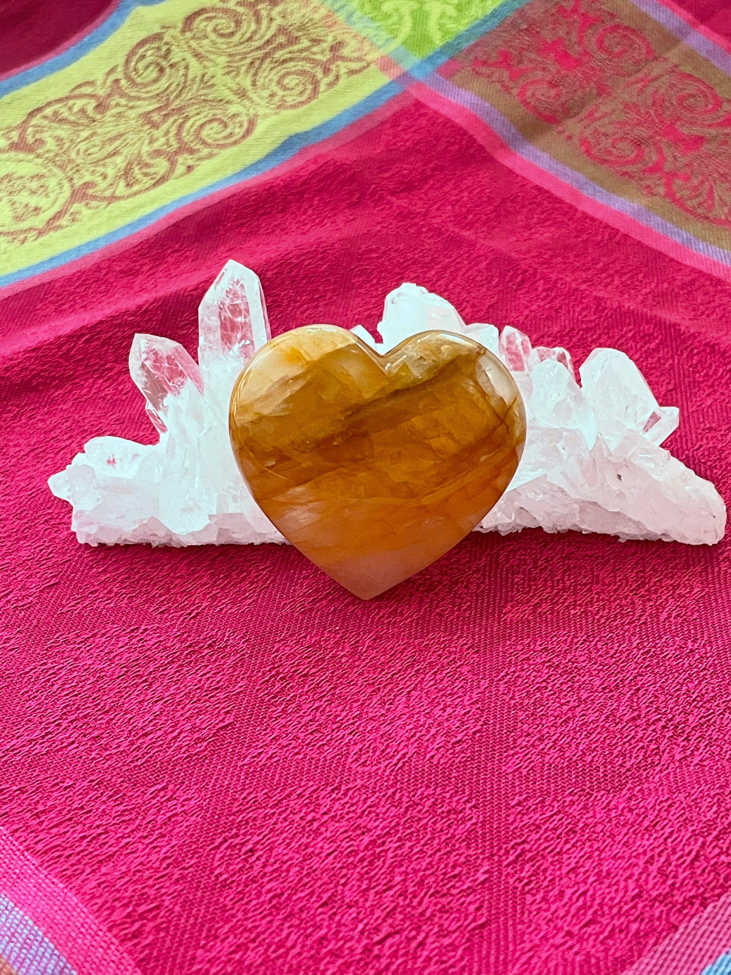Beautiful citrine heart! Great to place on your altar or bookshelf, to hold during meditation, to use for healing or as a décor item in your home of office. Citrine absorbs and dispels negative energy, is a stone of abundance - attracting money, prosperity and success, is warming & energizing, enhances creativity, brings a positive attitude, is cleansing and more. This citrine heart is approximately 2" at it's widest expanse. Cost $22. 
